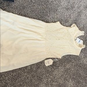 A cream colored lace party dress.
